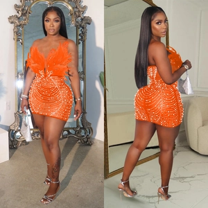 Detail of orange bodycon mini dress featuring luxury feather trim and pearl beading