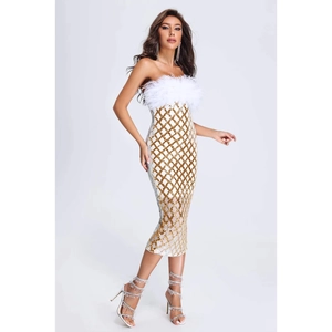 Detail of white tube dress featuring sequined gold diamond patterns and faux feather trim
