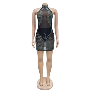 Detail of black mesh halter dress with sparkling silver rhinestone pattern on mannequin
