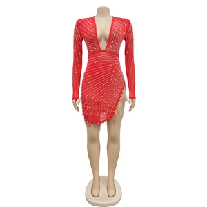 Detail of red deep V-neck dress with white pearls and feathered asymmetrical hem