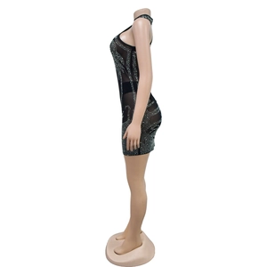 Detail view of black bodycon dress with sparkling silver rhinestones and halter neckline