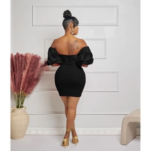 Detail of elegant black off-shoulder mini dress with puff sleeves and ruched back design