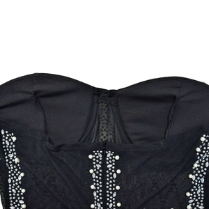 Close-up of black mesh romper featuring white pearls, rhinestones and center zipper detail