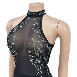Detail of mesh halter neck dress with sparkling silver rhinestones on black fabric