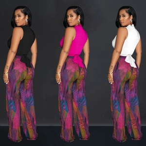 Detail of high neck tie-back top and colorful geometric print wide leg trousers set