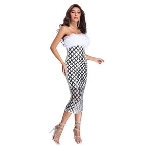 Detail of sequin dress featuring white feather trim and black-and-white diamond pattern