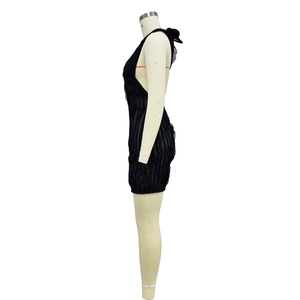 Close-up of black pleated fabric and back strap details of the sleeveless halter dress