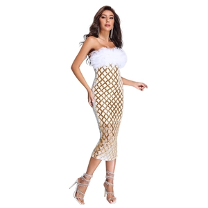Macro detail of white tube dress featuring golden sequins and plush feather neckline decor