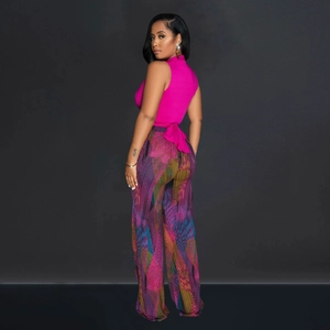 Detail of fuchsia knit halter top with decorative back bow and floral wide-leg trousers
