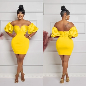 Close-up of yellow off-shoulder mini dress featuring dramatic puff sleeves and slim fit cut