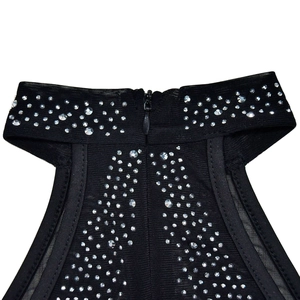Detail of black mesh dress featuring shimmering rhinestones and a back invisible zipper