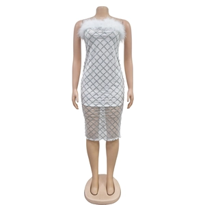 Detailed view of the white sequin bandeau dress with feather trim and silver lattice gems