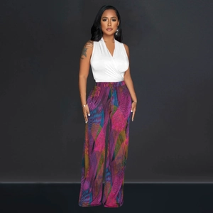 Close-up of vibrant wavy print on high-waist wide-leg pants and white V-neck top