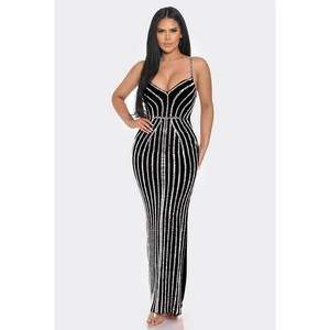 Detail of elegant black slim-fit evening dress featuring vertical sparkling sequins and straps