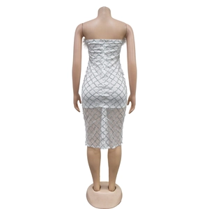 Detail of white sequin bandage dress featuring silver diamond pattern and feather trim back