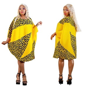 Detail of yellow pleated dress with blue leopard print panels and batwing sleeves