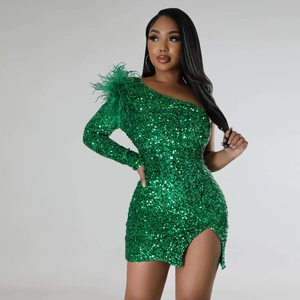 Detail of green sequin dress with feather shoulder accents and one-shoulder sleeve