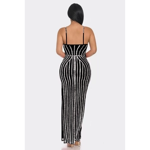 Detail of elegant black floor-length dress featuring vertical silver rhinestones and open back