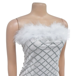 Detailed view of silver sequins and white feathers on a sequined strapless party dress