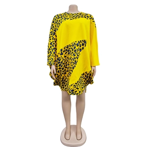 Detail of the vibrant leopard print pattern and yellow contrast on the long sleeve dress