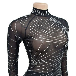 Detail of sheer black mesh top with intricate silver rhinestone geometric patterns