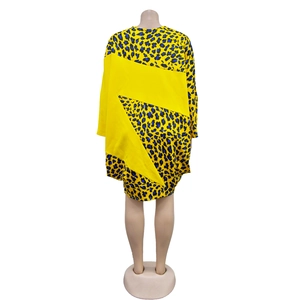 Back view of yellow long-sleeved dress with blue and black leopard print details
