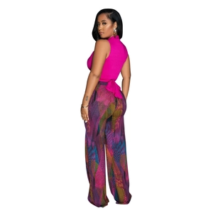 Detailed back view of sleeveless halter top and colorful abstract print wide leg trousers