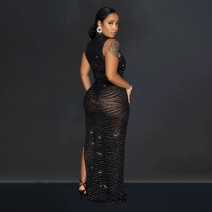 Detail of black sleeveless gown featuring shimmering silver rhinestone wave patterns