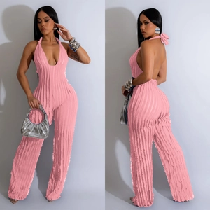 Detailed view of pink halter jumpsuit showing deep V-neck and open back with ribbed texture