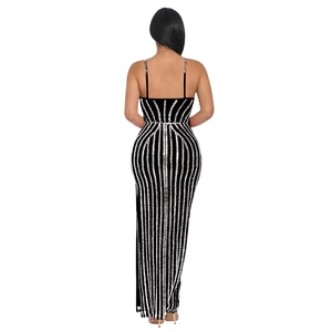 Detail of black slim fit maxi dress with silver sequins and thin back straps
