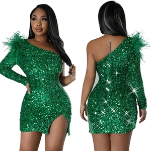 Detail of green sequin one-shoulder dress with feather trim and silver chain fringe