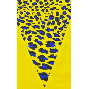 Detail of yellow dress with leopard print V-shaped patchwork and smooth fabric texture