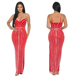 Detail of red slim fit maxi dress featuring white vertical rhinestone stripes on both sides