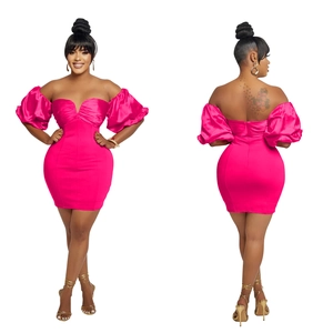 Detail of hot pink off-shoulder mini dress featuring pleated chest and open back design