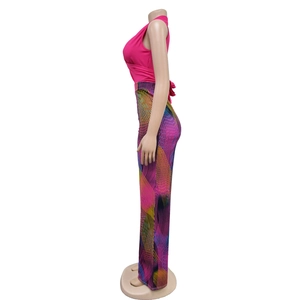 Detail of high-waist wide-leg trousers featuring vibrant geometric ray patterns and fabric texture