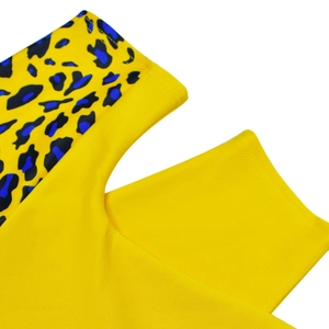 Detail of vibrant yellow fabric with modern blue and black leopard print stitching