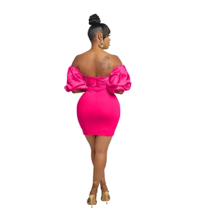 Detail of fuchsia off-shoulder mini dress featuring pleated bubble sleeves and an open back