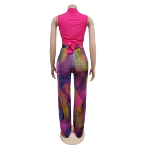 Detail showing back tie-up bow on hot pink top with colorful geometric striped wide leg pants