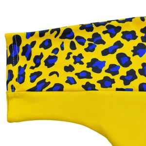 Detailed view of vibrant leopard print fabric with blue accents and elastic stitched hem