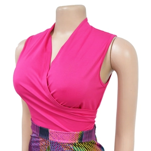 Detail view of pink sleeveless wrap V-neck top with colorful geometric printed pattern