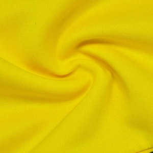 Close-up of bright yellow knit fabric texture showing high elasticity and soft drape