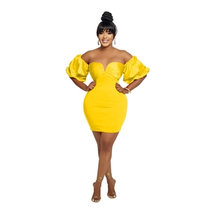 Detail of a bright yellow off-the-shoulder mini dress with puff sleeves and ruched chest