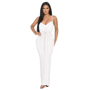 Detailed close-up of white slim-fit maxi dress featuring vertical sequins and spaghetti straps