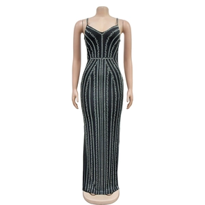 Detail of vertical silver sequins on black slim-fit maxi dress with V-neckline