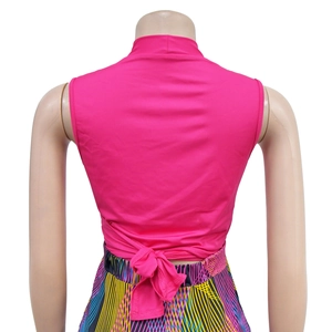 Detail of fuchsia backless tie-up top with bow knot and colorful printed pants