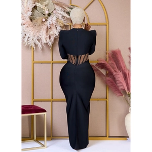 Detail of the open back and striped sheer cutouts on this elegant black maxi dress