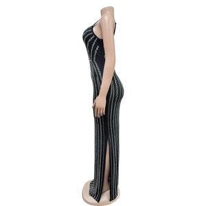 Detailed view of black slim-fit sleeveless maxi dress with shimmering silver rhinestone stripes