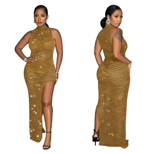 Detail of gold sleeveless high neck dress with wave pattern rhinestones and side slit