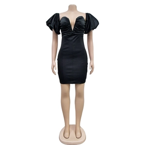 Close-up of black satin mini dress with puff sleeves and pleated V-neckline detail