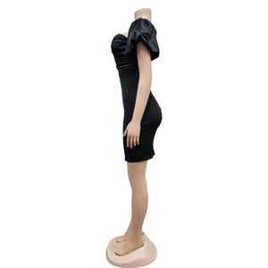 Side view of black bodycon dress featuring puffed sleeves and elegant ruching details